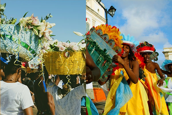 Pessoas com cestos de flores na cabeça e ao lado duas pessoas no carnaval da Bahia